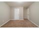 Vacant bedroom featuring neutral walls and carpeting at 5136 Huxley Rd, Stone Mountain, GA 30088