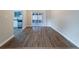 Open dining area with wood-look flooring, sliding glass door leading to a screened porch, and view of the kitchen at 5136 Huxley Rd, Stone Mountain, GA 30088