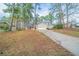 Charming two-story home with driveway, grassy front yard, and trees at 5136 Huxley Rd, Stone Mountain, GA 30088