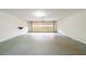 Spacious attached garage with overhead door and concrete floor at 5136 Huxley Rd, Stone Mountain, GA 30088