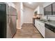 Bright, updated kitchen with white cabinets, stainless steel appliances, and granite countertops at 5136 Huxley Rd, Stone Mountain, GA 30088