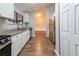 View of the updated kitchen with white cabinets, granite countertops, and stainless steel appliances at 5136 Huxley Rd, Stone Mountain, GA 30088