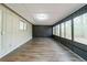 Bright sunroom with wood-look flooring and large windows at 5136 Huxley Rd, Stone Mountain, GA 30088