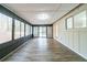 Sunroom with many windows, wood-look floors, and access to backyard at 5136 Huxley Rd, Stone Mountain, GA 30088