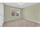 Empty bedroom with neutral carpet and single window at 1558 Park Knoll Trl, Lawrenceville, GA 30043