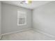 Empty bedroom with neutral gray walls, carpeted flooring, and a window at 2230 Whitestone Pl, Alpharetta, GA 30005