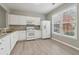 Bright kitchen with white cabinets, granite countertops, and stainless steel appliances at 2230 Whitestone Pl, Alpharetta, GA 30005