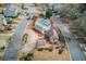 Aerial view of community pool, clubhouse, and surrounding townhouses at 3263 Long Iron Pl, Lawrenceville, GA 30044