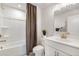 Modern bathroom with white vanity, shower, and gold fixtures at 443 Village Ln, Fairburn, GA 30213