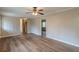 Living room with hardwood floors, a ceiling fan, and an open doorway to another room at 4485 Canary Ct, Lithia Springs, GA 30122