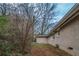 View of the backyard and side of the house with trees and bushes at 2131 Meador Se Ave, Atlanta, GA 30315