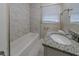 Bathroom with tiled shower, granite vanity, and modern fixtures at 2131 Meador Se Ave, Atlanta, GA 30315