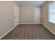 Cozy bedroom with neutral walls, carpeting, and two doors at 2131 Meador Se Ave, Atlanta, GA 30315