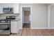 Kitchen with white cabinets, stainless steel appliances, and a view down the hallway at 2131 Meador Se Ave, Atlanta, GA 30315