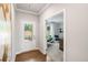 Welcoming entryway with wood floors, white door, and a view into a home office at 476 Village Ln, Fairburn, GA 30213