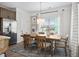 Dining area with a wooden table, chairs, and natural light from large windows at 733 Shetland Trl, Cartersville, GA 30121