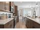 Modern kitchen with dark wood cabinets, stainless steel appliances, white countertops, and an island at 733 Shetland Trl, Cartersville, GA 30121