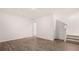 Finished basement with wood laminate flooring, white walls, and carpeted stairs at 979 Cades Walk, Lawrenceville, GA 30045