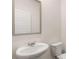 Clean, modern bathroom with a pedestal sink and a large mirror at 979 Cades Walk, Lawrenceville, GA 30045