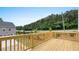 Wooden deck overlooking a driveway, trees, and a street at 979 Cades Walk, Lawrenceville, GA 30045