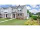 Exterior elevation of a townhome with landscaping, siding, and brick at 979 Cades Walk, Lawrenceville, GA 30045