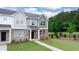 Front exterior of a townhome with brick and siding, and landscaping at 979 Cades Walk, Lawrenceville, GA 30045