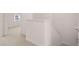 Carpeted hallway with half wall by staircase at 979 Cades Walk, Lawrenceville, GA 30045