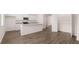 Kitchen and dining area with white cabinets, wood-style flooring, and a pantry at 979 Cades Walk, Lawrenceville, GA 30045