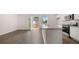 Kitchen and dining area with wood-look flooring, white cabinets, granite counters, and stainless steel appliances at 979 Cades Walk, Lawrenceville, GA 30045