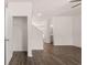 Living room with wood-look flooring, white walls, coat closet, and stairs at 979 Cades Walk, Lawrenceville, GA 30045