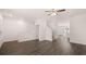 Living room with wood-look floors, white walls, ceiling fan, and stairs at 979 Cades Walk, Lawrenceville, GA 30045