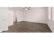 Living room with wood-look flooring, white walls, and ceiling fan at 979 Cades Walk, Lawrenceville, GA 30045