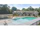 Community pool and clubhouse with townhomes in the background at 979 Cades Walk, Lawrenceville, GA 30045