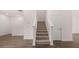 Carpeted staircase with white railings and wood-style flooring at 979 Cades Walk, Lawrenceville, GA 30045