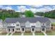 Townhomes with gray and white siding, brick fronts, and landscaping at 979 Cades Walk, Lawrenceville, GA 30045
