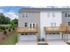 Back view of townhomes with balconies above garages at 979 Cades Walk, Lawrenceville, GA 30045