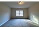 Bright bedroom with large window and carpet flooring at 55 Hawthorn Ln, Covington, GA 30014