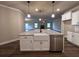 Kitchen island with a farmhouse sink, dishwasher, and white cabinets at 55 Hawthorn Ln, Covington, GA 30014