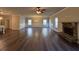 Large living room with a stone fireplace and wood-look flooring at 55 Hawthorn Ln, Covington, GA 30014