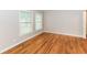 Empty room with hardwood floors, large windows, and neutral-colored walls, ideal for a bedroom or office at 2454 Spring Garden Sw Dr, Atlanta, GA 30315