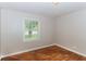 A bedroom or office space with hardwood floors, a large window, and neutral walls at 2454 Spring Garden Sw Dr, Atlanta, GA 30315
