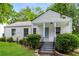 Charming white home with covered front porch, landscaping, and steps leading to the entrance at 2454 Spring Garden Sw Dr, Atlanta, GA 30315