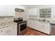 Updated kitchen with stainless steel appliances, granite countertops, and ample cabinet space at 2454 Spring Garden Sw Dr, Atlanta, GA 30315