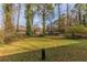 Backyard with grassy lawn and trees at 1852 Shamrock Dr, Decatur, GA 30032
