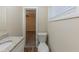 Bathroom with granite countertop, white vanity, and toilet at 1852 Shamrock Dr, Decatur, GA 30032
