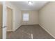 Empty bedroom with carpeted flooring, blinds on the window, and neutral walls at 1852 Shamrock Dr, Decatur, GA 30032