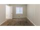 Empty bedroom featuring wood panel walls, carpeted floors and a window with blinds at 1852 Shamrock Dr, Decatur, GA 30032