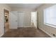 View of a bedroom with carpet, closet doors, and a window at 1852 Shamrock Dr, Decatur, GA 30032