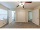 Bedroom with carpet, ceiling fan, closet doors, and open doorways at 1852 Shamrock Dr, Decatur, GA 30032