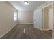 Empty bedroom with carpeted floors and a window with blinds at 1852 Shamrock Dr, Decatur, GA 30032